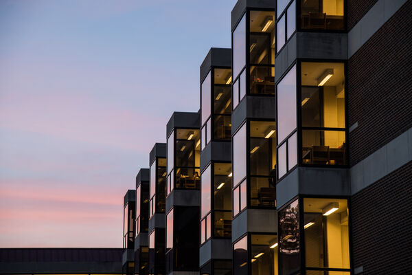 The exterior of the Undergraduate Library (UGLI) with at sunset with pink streaks in the sky. 