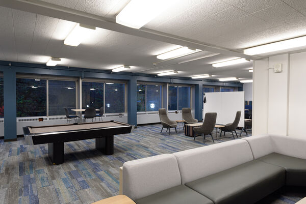 Bursley's game room with a pool table and couches