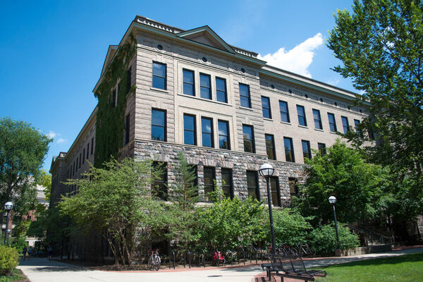 The corner of the four-story Dana Building on a sunny day
