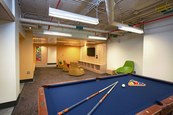 A lounge with a pool table