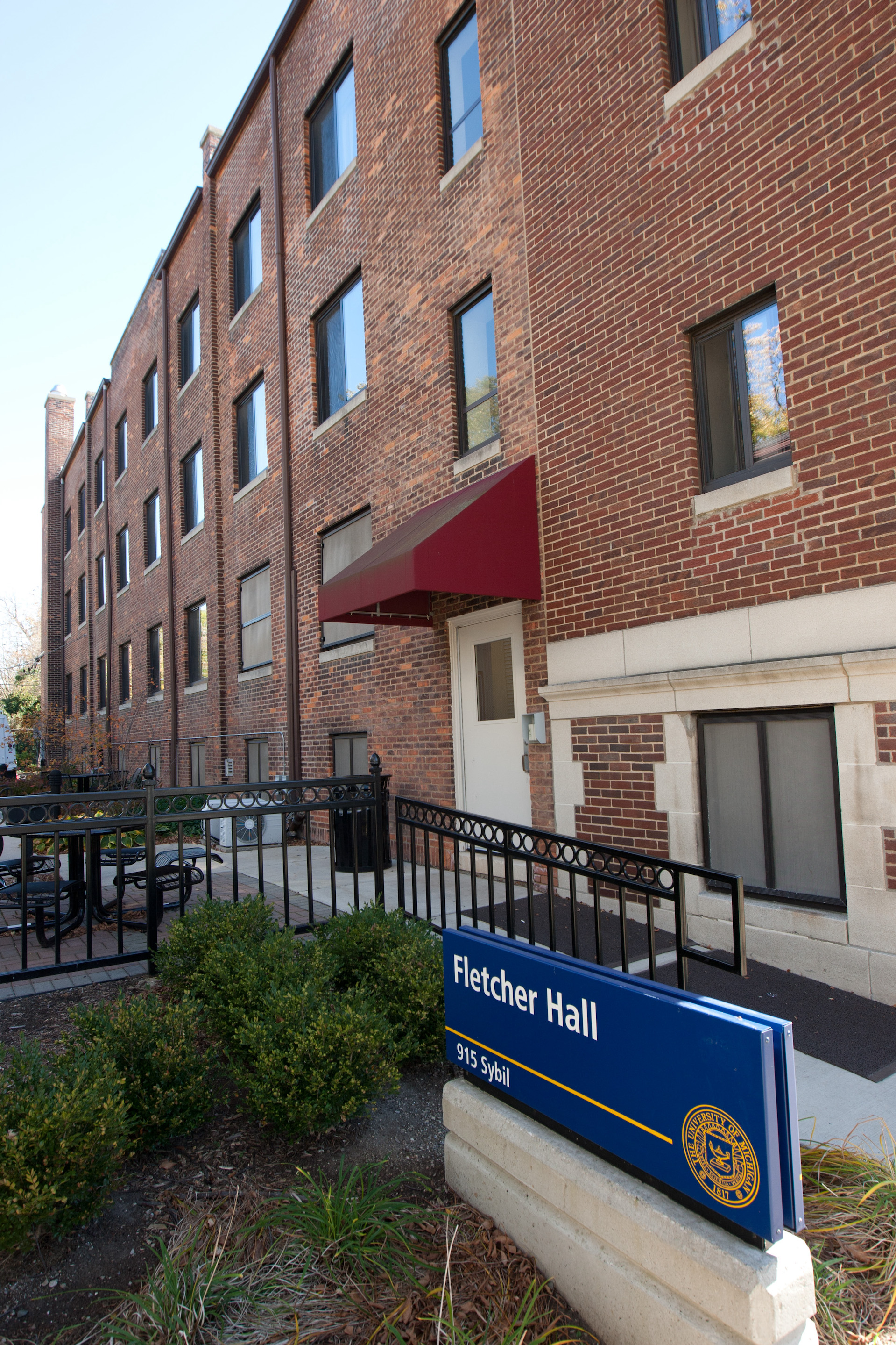 Front view of Fletcher Hall with its campus sign