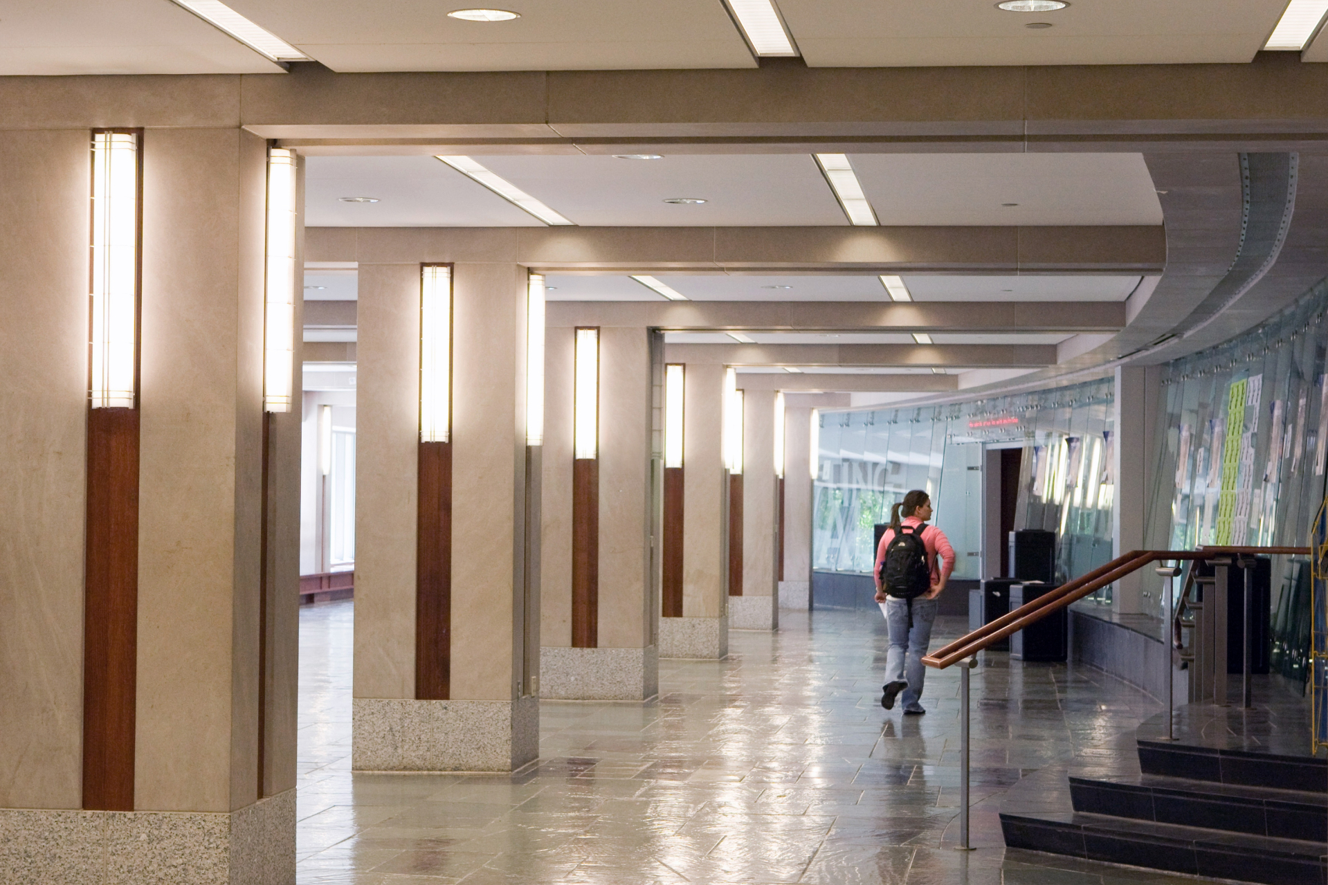 A hallway with modern lighting and stairway inside of Haven Hall