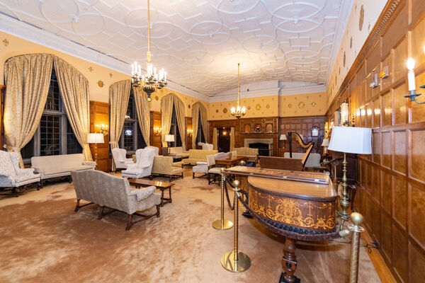An ornate grand piano in one of the common areas at Martha Cook