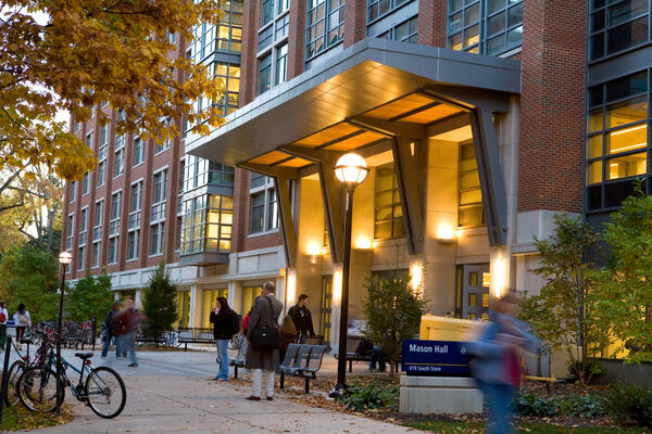 The entrance to Mason Hall from the Diag at dusk with the entrance lights on