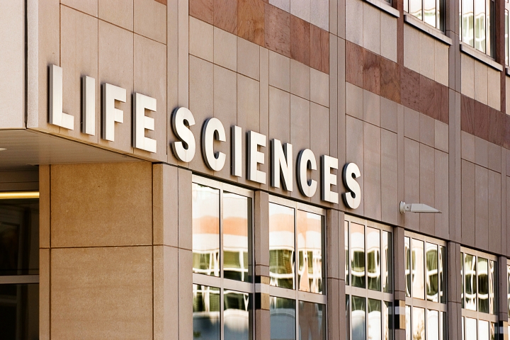 The marble exterior of the LSI building with "Life Sciences" in large letters above the entrance.